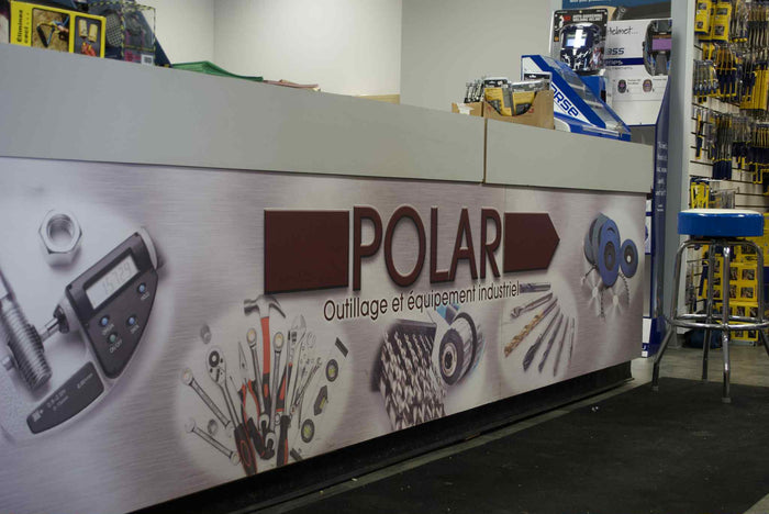 Industrial tools and equipment displayed on a counter with POLAR branding and a variety of hand tools and components shown