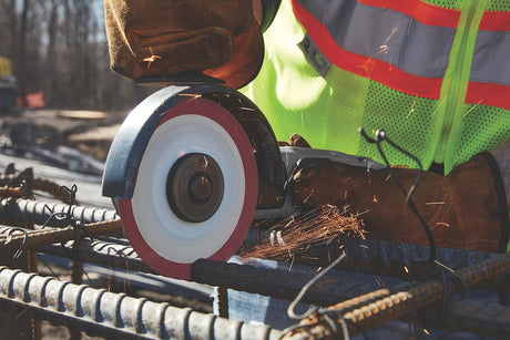 Cutting metal rebar with handheld power saw equipped with LENOX Metal Max cutting blade generating sparks