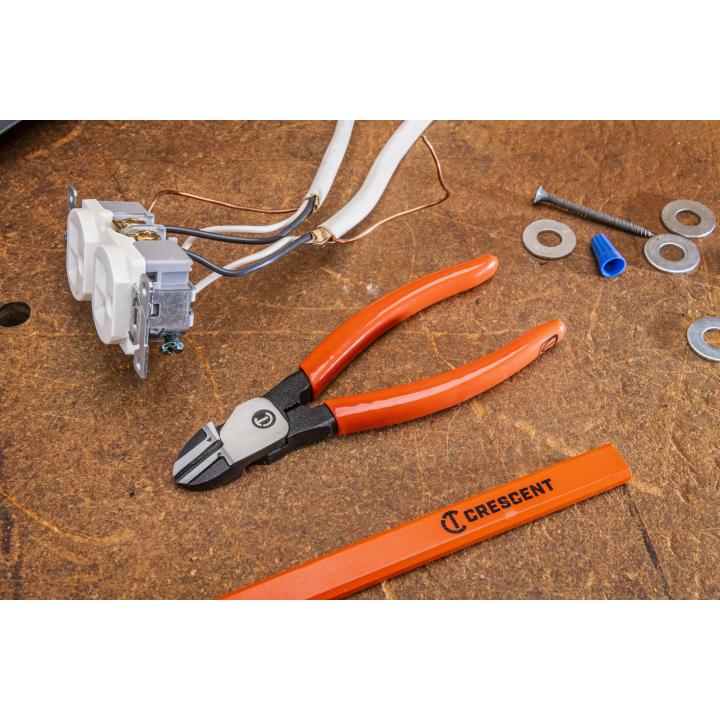 6-inch Crescent diagonal cutting pliers with ergonomic orange handles on a workbench with electrical components