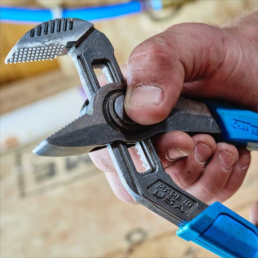 Close-up of Channellock GS-3 adjustable groove joint pliers with blue grips held in hand on workshop background