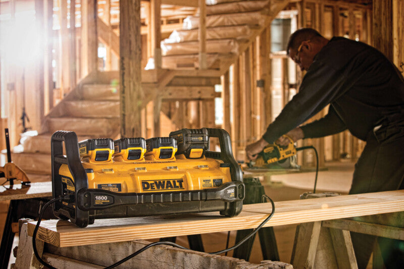 DeWalt 1800W portable charging station with multiple battery slots and sturdy handle, used on construction site