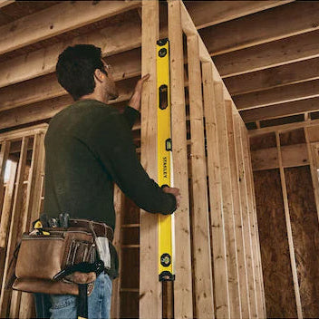 48-inch Stanley box level with central vial, durable frame, and shock-absorbing end caps used in wood framing construction