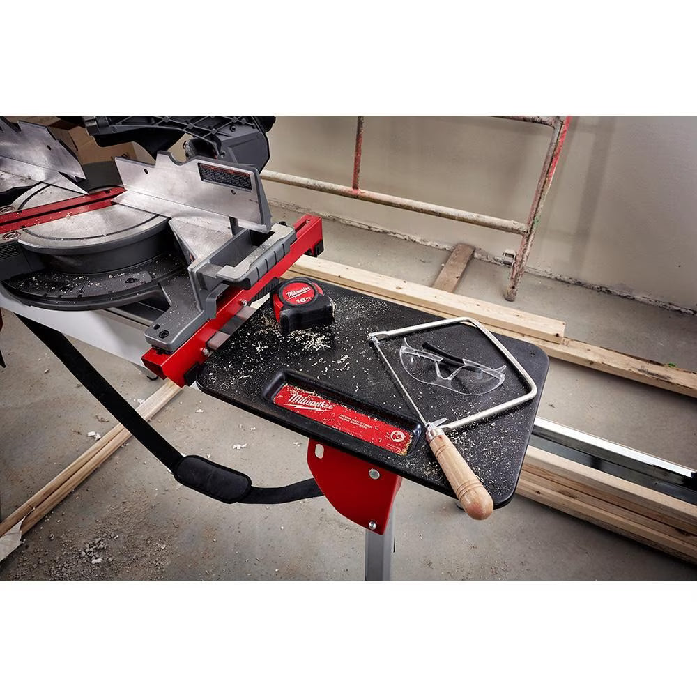 7-1/4 inch m18 fuel double bevel miter saw with safety glasses, tape measure, and hacksaw on work table