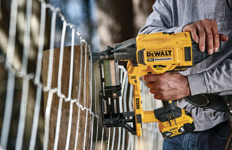 Cordless DEWALT 9GA fence stapler with 20V battery, designed for fast and efficient rural fencing applications