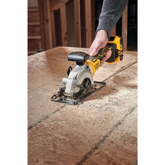 Cordless 4-1/2 inch circular saw kit with integrated blade storage and ergonomic trigger for precision cutting tasks
