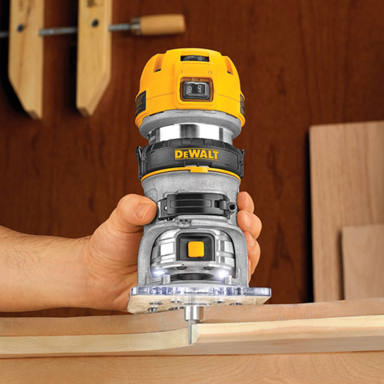Compact variable-speed DeWalt router with 1.25 HP motor and LED lights for precise woodworking tasks